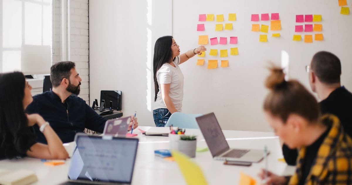 Team planning a digital business on a glass board