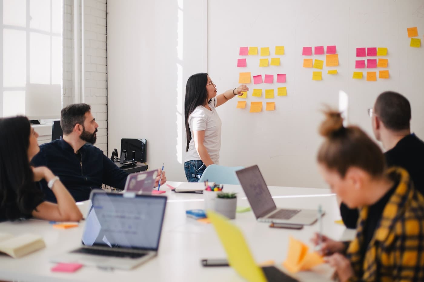 Team planning a digital business on a glass board