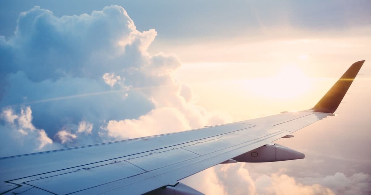 Airplane wing above clouds